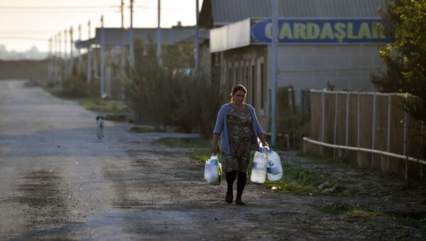 Женщина с емкостями с водой в селе Чоджук Марджанлы Джебраильского района. - Sputnik Азербайджан