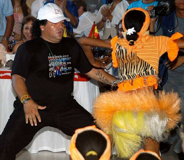 Легенда футбола Диего Марадона танцует на вечеринке в честь завершения карьеры колумбийского футболиста Карлоса Вальдеррамы, 2004 год - Sputnik Azərbaycan