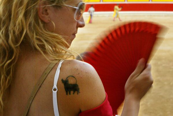 Женщина с татуировкой быка на плече во время корриды на ярмарке Сан-Фермин, Испания - Sputnik Азербайджан