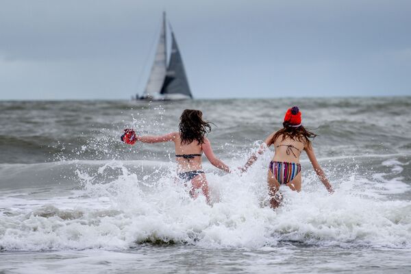 Девушки забегают в море в Схевенингене, Нидерланды - Sputnik Azərbaycan