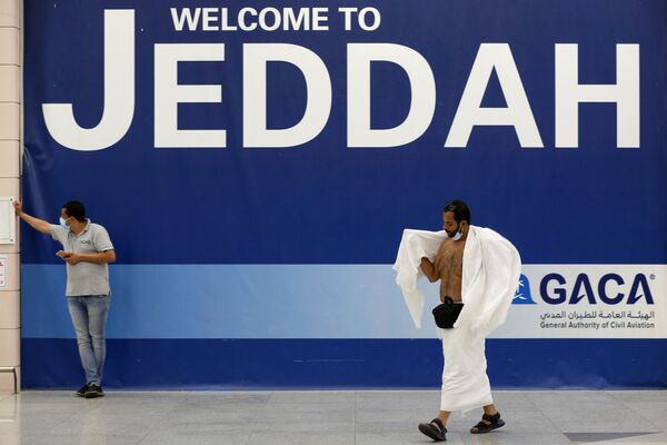 Мусульманский паломник в белой одежде прибывает в международный аэропорт имени короля Абдель Азиза в преддверии ежегодного паломничества хаджа в Джидде, Саудовская Аравия - Sputnik Азербайджан