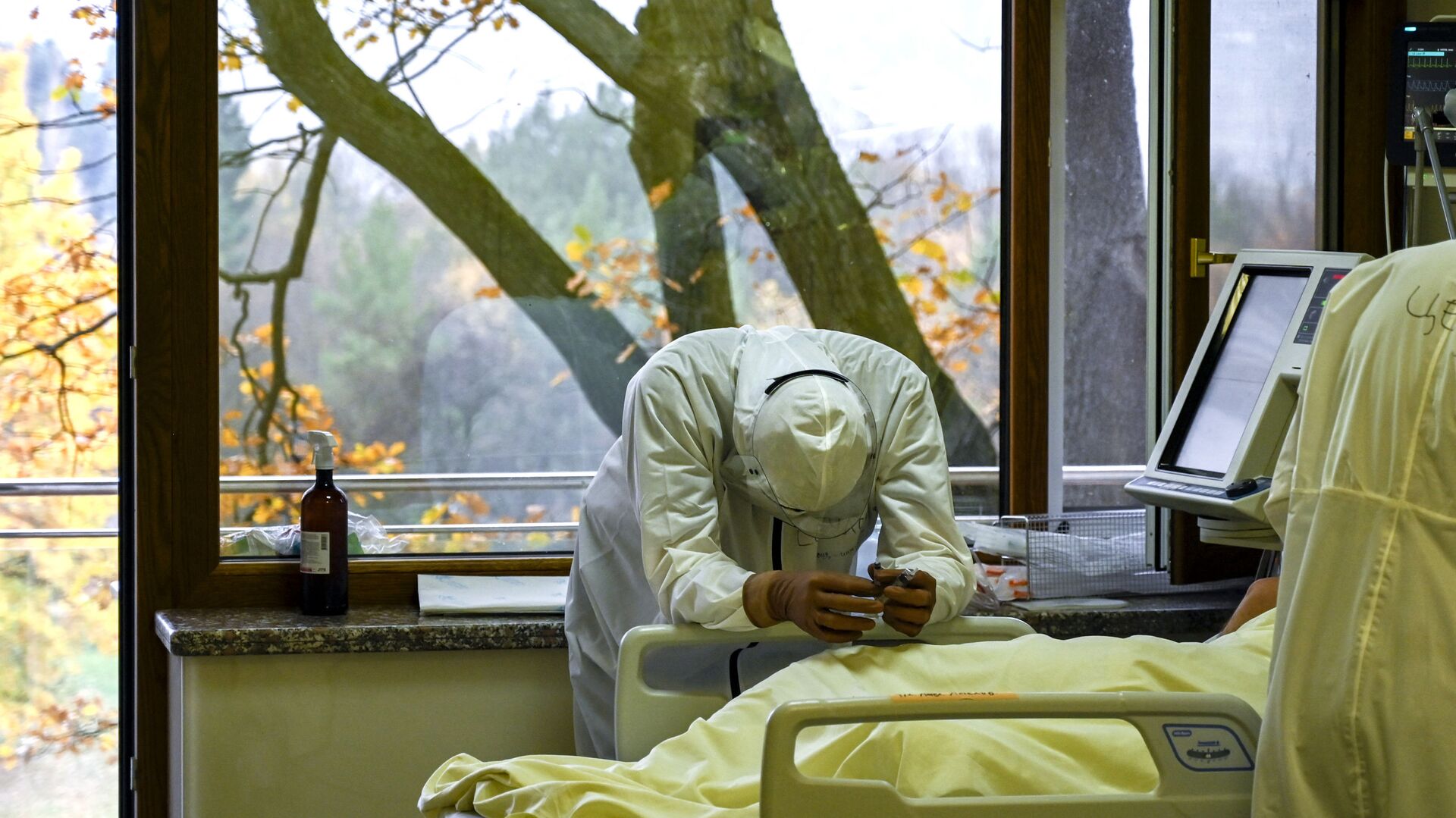 Медицинский работник рядом с пациентом в отделении интенсивной терапии больницы Лозенец в Софии - Sputnik Азербайджан, 1920, 01.12.2021