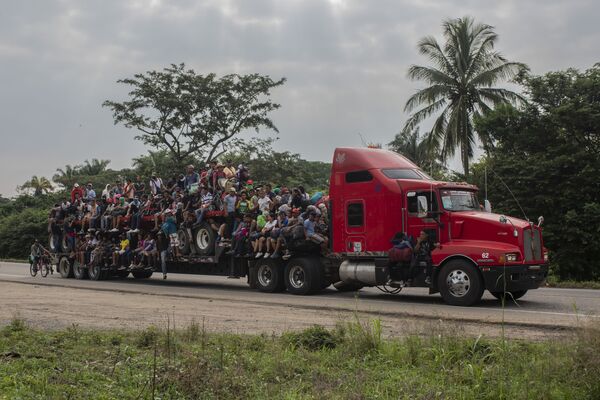 Мигрантов перевозят на платформе трейлера в Хесус-Карранса, Мексика. - Sputnik Азербайджан