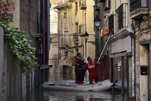 Спасательная команда помогает женщине в затопленном районе в Туделе, Испания. - Sputnik Азербайджан