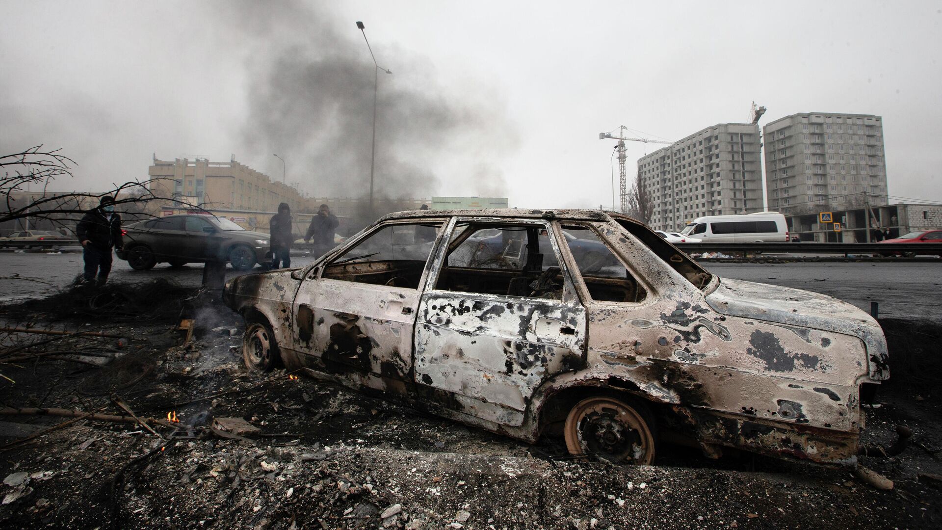 Сгоревший во время протестов автомобиль на улице в Алматы, Казахстан, 9 января 2022 года - Sputnik Азербайджан, 1920, 12.01.2022