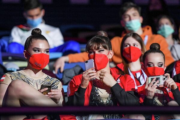 Гимнастки из Австрии наблюдают за выступлениями своих соперниц. - Sputnik Азербайджан