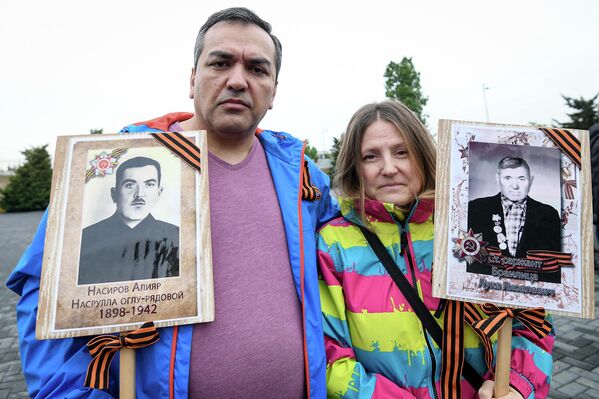 Участники мероприятия пришли к Мемориалу с портретами своих отцов и дедов, отдавших жизнь по имя Победы. - Sputnik Азербайджан