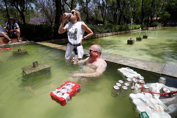 Болельщики пьют пиво, охлаждаясь в воде в центре Севильи, Испания. - Sputnik Азербайджан