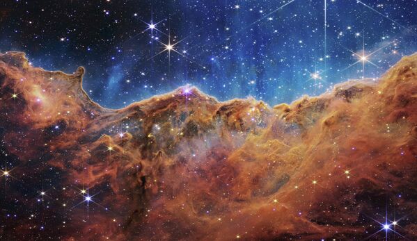 Изображение с космического телескопа JWST, впервые показывает невидимые ранее области рождения звезд. - Sputnik Азербайджан