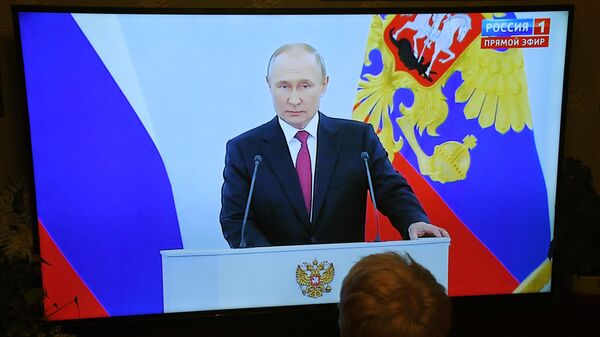 Женщина смотрит телевизионную трансляцию выступления президента Российской Федерации Владимира Путина  - Sputnik Азербайджан