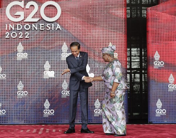 Президент Индонезии Джоко Видодо (слева) приветствует генерального директора Всемирной торговой организации (ВТО) Нгози Оконджо-Ивеала, прибывающую на саммит лидеров G20 в Нуса-Дуа, на индонезийский курортный остров Бали. - Sputnik Азербайджан