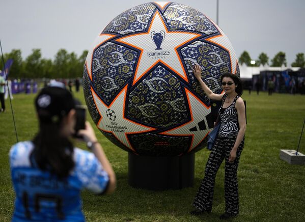 Женщина фотографирует макет футбольного мяча в Стамбуле. - Sputnik Азербайджан