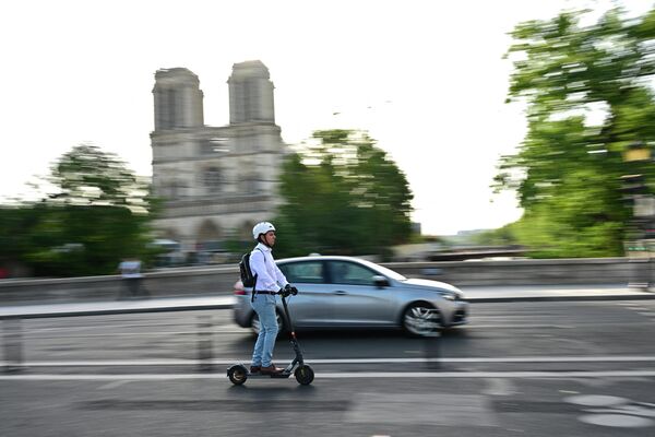 Мужчина едет на электросамокате в Париже. - Sputnik Азербайджан