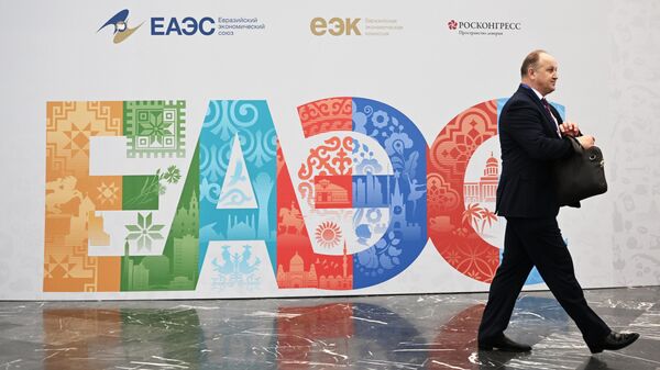  Участники проходят рядом со стендом с символикой Евразийского экономического форума - Sputnik Азербайджан