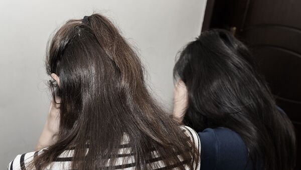 Молодые девушки, скрывающие лицо, архивное фото - Sputnik Азербайджан
