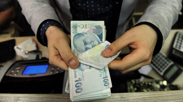 Сотрудник обменного пункта с турецкими банкнотами в руках, фото из архива - Sputnik Azərbaycan