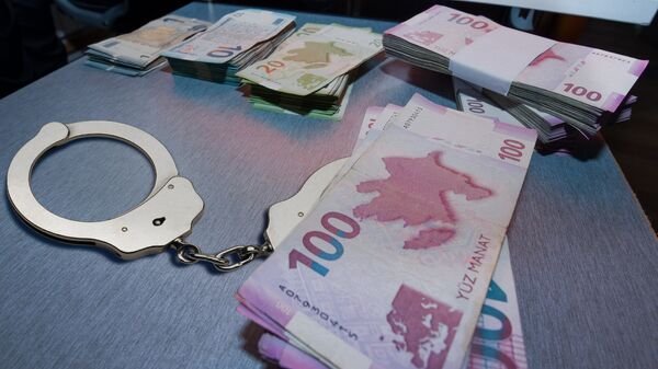 Наручники и пачки денег на столе, фото из архива - Sputnik Азербайджан