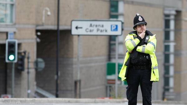 Офицер британской полиции у стадиона Манчестер Арена во время оцепления после теракта - Sputnik Азербайджан