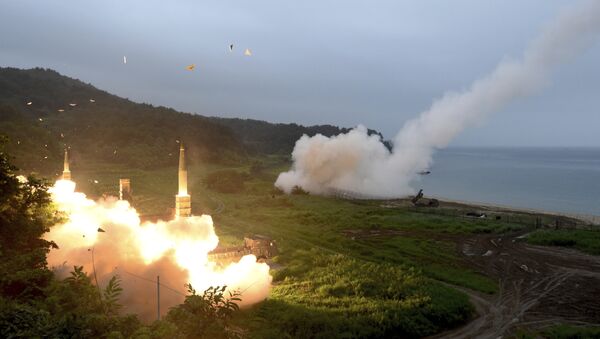 In this photo provided by South Korea Defense Ministry, South Korea's Hyunmoo II Missile system, left, and U.S. Army Tactical Missile System, right, fire missiles during the combined military exercise between the two countries against North Korea at an undisclosed location in South Korea, Saturday, July 29, 2017. - Sputnik Azərbaycan