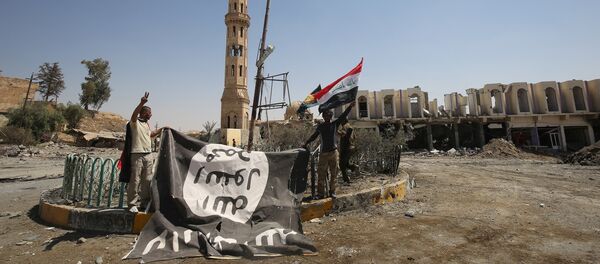 Боевики коалиции Силы народной мобилизации, сражающейся на стороне иракского правительства, фотографируются с флагом ИГ в городе Талль-Афаре, Ирак, 27 августа 2017 года - Sputnik Азербайджан