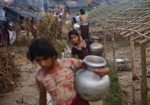 Девочки из семей беженцев-рохинджа идут за водой в лагере Балухали в Бангладеш - Sputnik Azərbaycan