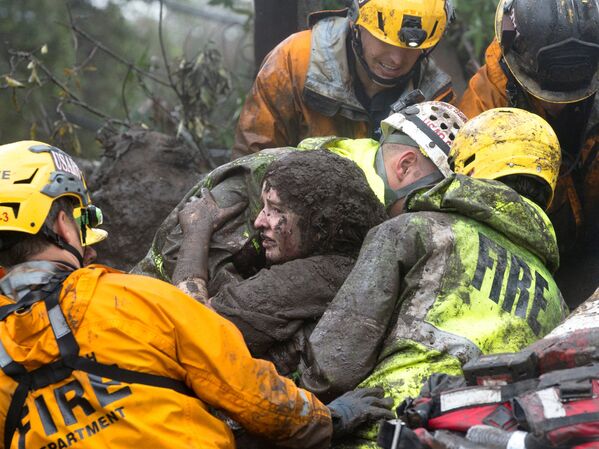 Спасатели достают женщину из под завалов ее дома, который был разрушен оползнем в Монтесито, Калифорния - Sputnik Азербайджан
