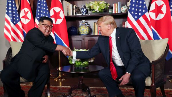 U.S. President Donald Trump shakes hands with North Korea's leader Kim Jong Un before their bilateral meeting at the Capella Hotel on Sentosa island in Singapore June 12, 2018. - Sputnik Azərbaycan