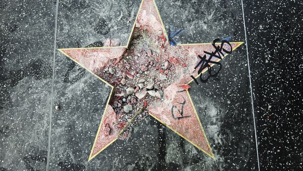 This photo shows Donald Trump's star on the Hollywood Walk of Fame that was vandalized Wednesday, July 25, 2018, in Los Angeles. Los Angeles police Officer Ray Brown said the vandalism was reported early Wednesday and someone was subsequently taken into custody. Authorities said a pickax was used in the vandalism - Sputnik Azərbaycan