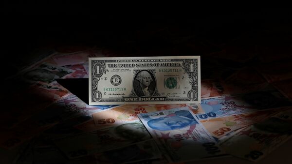 A U.S. dollar banknote is seen on top of Turkish lira banknotes in this picture illustration in Istanbul, Turkey August 14, 2018 - Sputnik Azərbaycan