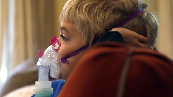 Мальчик сидит и смотрит мультфильм во время лечения астмы - Sputnik Азербайджан