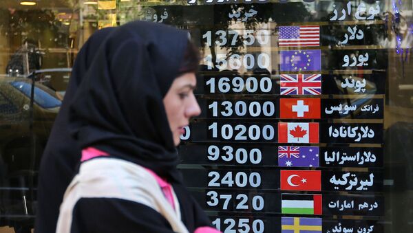 Иранская женщина проходит мимо пункта обмена валюты в столице страны Тегеране - Sputnik Азербайджан