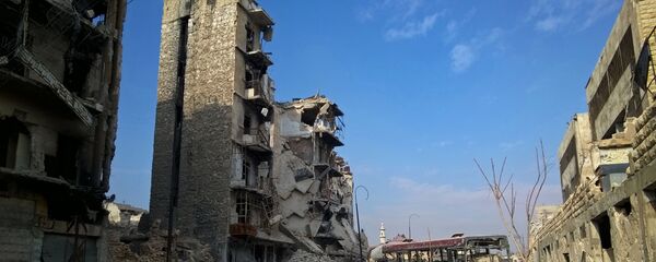 Здания, разрушенные в ходе боевых действий между правительственными войсками и боевиками в одном из районов восточной части сирийского Алеппо Здания, разрушенные в ходе боевых действий между правительственными войсками и боевиками в одном из районов восточной части сирийского Алеппо - Sputnik Азербайджан