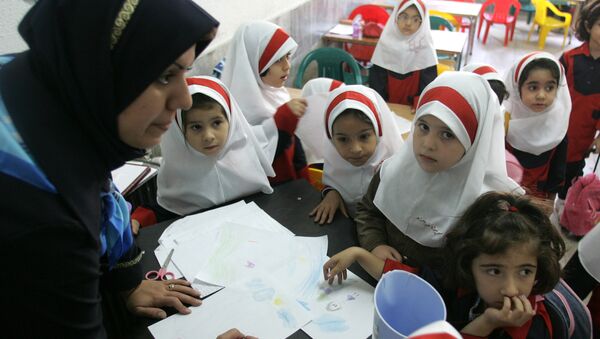 Иранские школьницы собрались вокруг своего учителя в классе в школе Сиздах Абан на севере Тегерана  - Sputnik Азербайджан