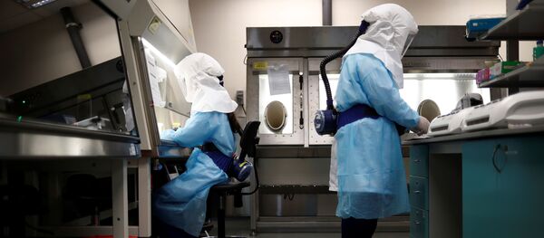 Home Team Science & Technology Agency (HTX) scientists demonstration the test process of their coronavirus test kit  - Sputnik Азербайджан