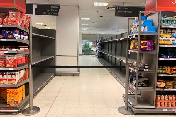 Empty shelves are seen in a now closed aisle at a supermarket in Canary Wharf, as the number of coronavirus cases grow around the world  - Sputnik Азербайджан