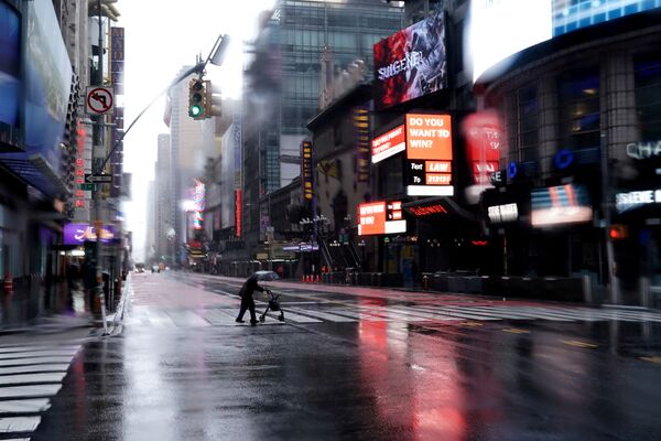 Человек пересекает 42-ую улицу на пустынном Таймс-сквер в Нью-Йорке - Sputnik Азербайджан