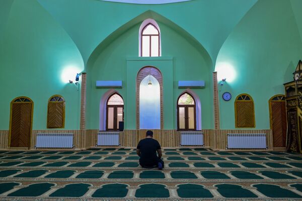 Один из прихожан в мечети во время намаза - Sputnik Azərbaycan