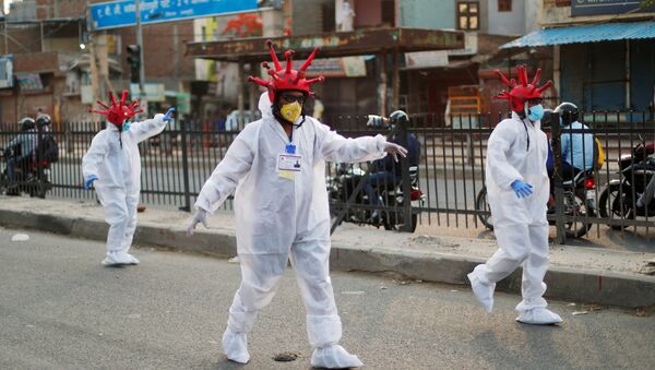 Артисты в шлемах в форме коронавируса и защитных костюмах на улице в Нью-Дели, фото из архива - Sputnik Azərbaycan