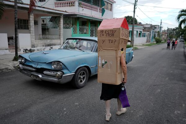 Женщина в картонной конструкции для защиты от коронавируса на улице в Гаване, Куба - Sputnik Азербайджан
